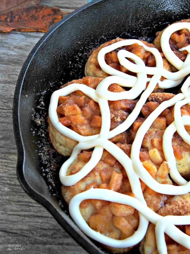 Apple-Pie-Angel-Biscuits are southern style biscuits baked in a cast iron skillet and topped with cinnamon apple pie filling and elegant drizzle of gooey cream cheese icing.