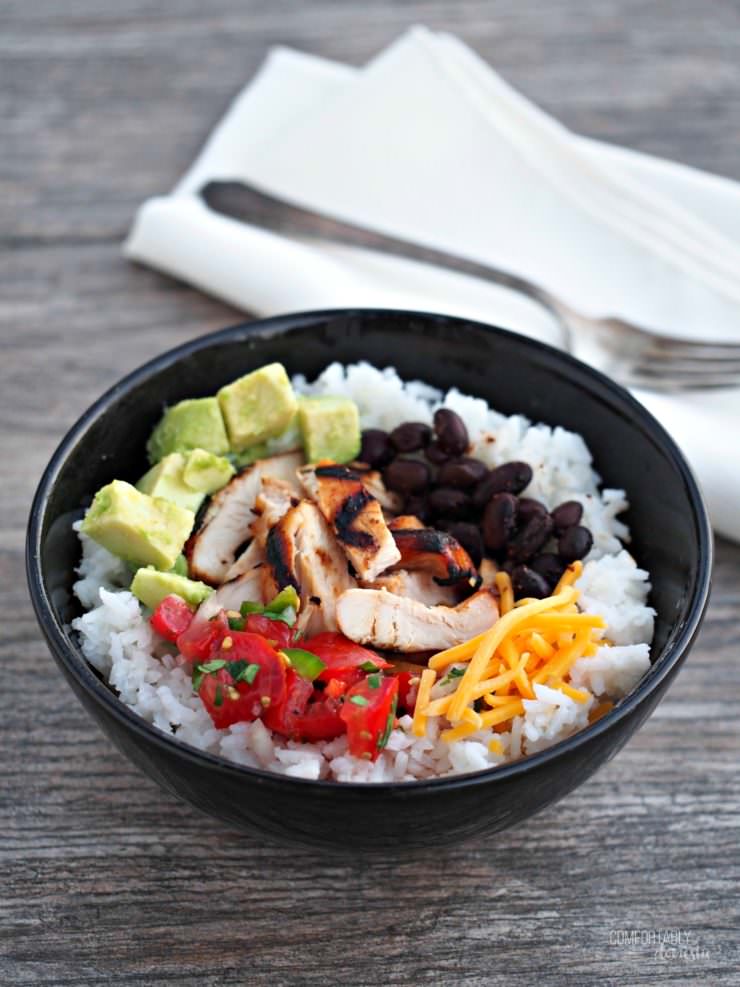 Chicken-Burrito-Bowls nestle perfectly seasoned chicken atop a bed of fluffy lime-cilantro rice along with roasted black beans and all the trimmings for a healthy dinner with loads of flavor. A copy cat recipe of the Chipotle restaurant favorite.