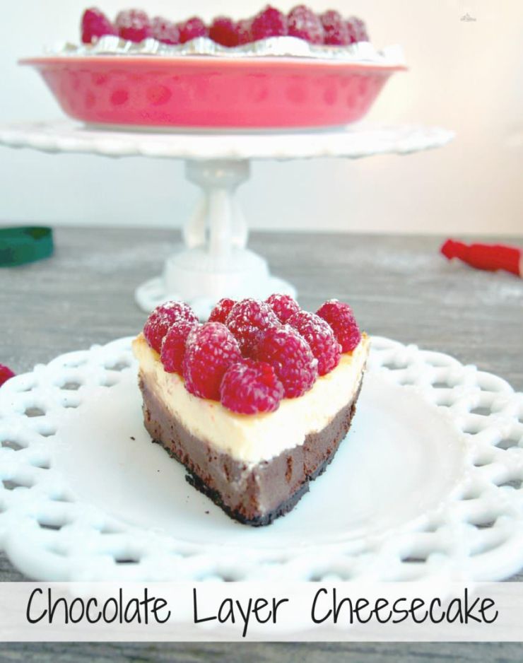 Chocolate-Layer-Cheesecake has a rich layer of vanilla cheesecake resting atop a decadent layer of chocolate cheesecake nestled in a chocolate cookie crust. Topped with fresh raspberries and whipped cream, this cheesecake is a showstopper!