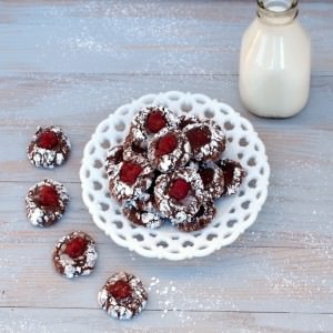 Chocolate thumbprint cookies are the perfect Christmas cookie! Tangy raspberry jam, cradled in lush chocolate cookie dough, coated with a heavy dusting of powdered sugar. They're a sweet cookie that virtually melts on the tongue. | ComfortablyDomestic.com