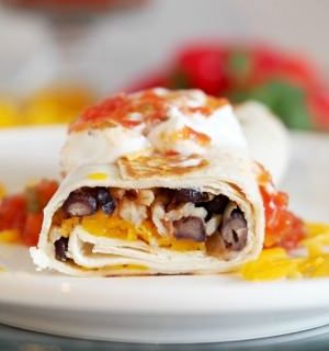 Crispy-Black-Bean-Burritos combine black beans with sautéed vegetables, brown rice, and cheddar cheese for a healthy, balanced vegetarian meal with complete proteins, all wrapped in a toasted tortilla.