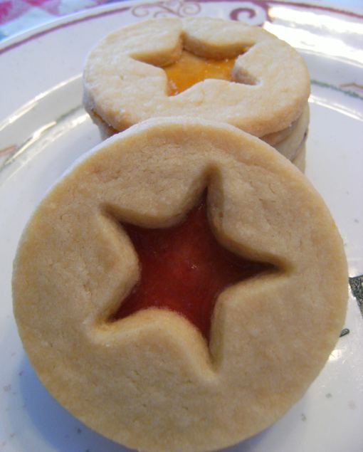 Shortbread linzer cookies are rich buttery shortbread cookies with a thin layer of preserves sandwiched between them to look like linzer cookies.