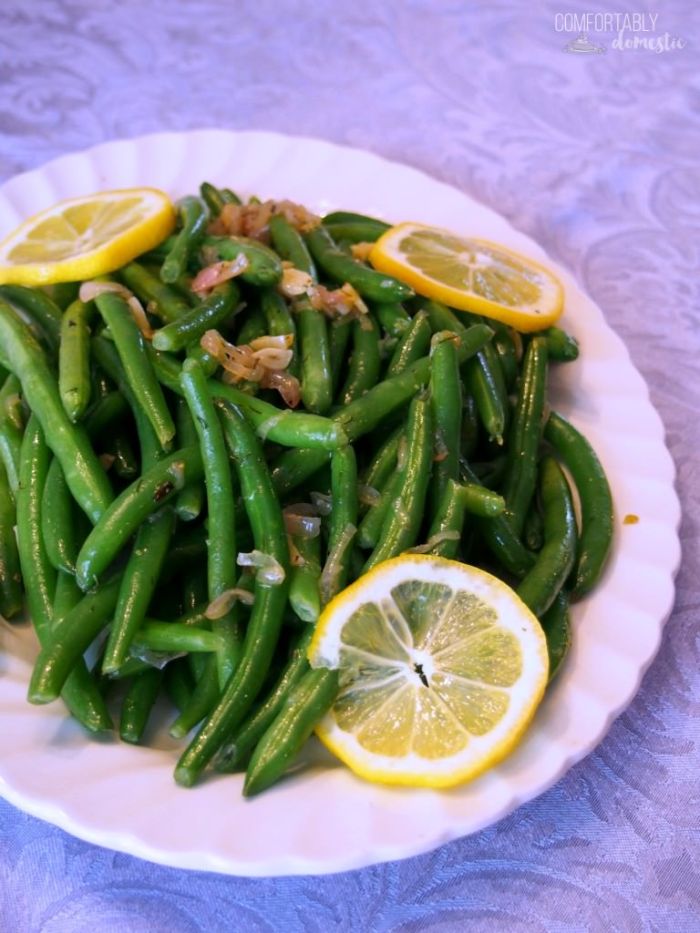 Garlic green beans are a delicious, easy to make holiday side dish! Fresh green beans are lightly steamed and tossed with a bright, lemon garlic butter sauce with caramelized shallots. | Get the recipe from ComfortablyDomestic.com