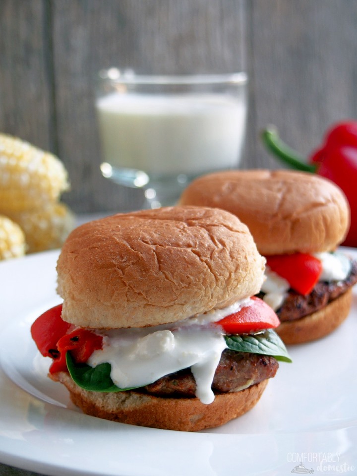 Two Greek turkey sliders on a white plate.