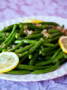 Garlic green beans are a delicious, easy to make holiday side dish! Fresh green beans are lightly steamed and tossed with a bright, lemon garlic butter sauce with caramelized shallots. | Get the recipe from ComfortablyDomestic.com