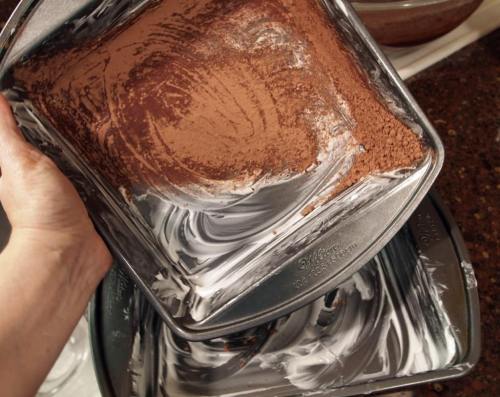 greasing and dusting a cake pan for a chocolate cake.