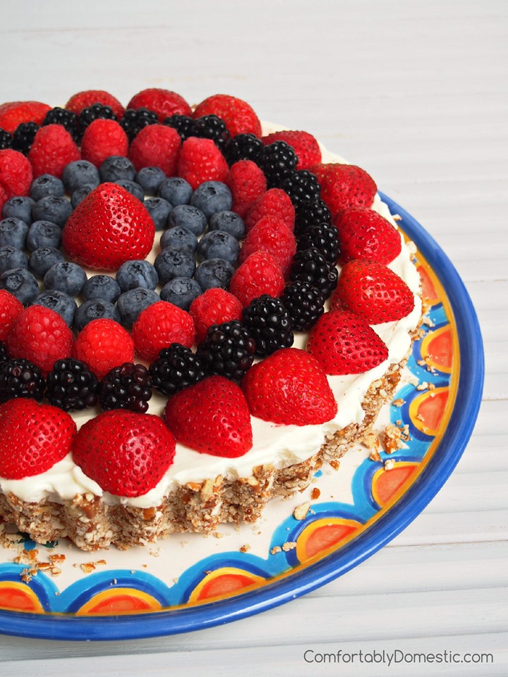 Lemon Mousse Tart with fresh berries arranged on top. 