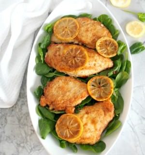 Lemon butter chicken is boneless chicken breast, pan seared in butter with garlic and lemon, then served over wilted spinach. | ComfortablyDomestic.com