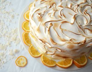 The balance of flavors and textures between moist cake, creamy lemon curd, and toasted Swiss meringue makes this Coconut Meyer Lemon Cake recipe a winner! | ComfortablyDomestic.com