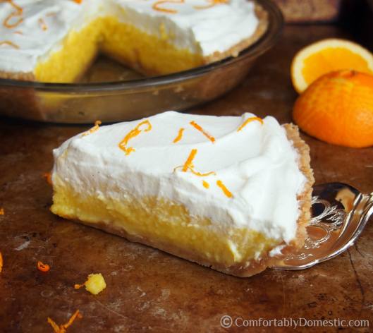 Orange cream pie is sweet-tart orange curd nestled on a Nilla wafer cookie crust, then topped with lightly sweetened whipped cream. | ComfortablyDomestic.com