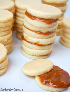 Alfajores are simple, buttery shortbread sandwich cookies filled with dulce de leche, popular in Latin American countries. | ComfortablyDomestic.com