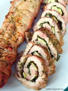 Rosemary Pesto Pork Roulade - Tender pork tenderloin is butterflied, rubbed with a flavorful fresh rosemary pesto, filled with fresh spinach, thinly sliced apples, and smoky gouda cheese before being tied, roasted, and served sliced into succulent pinwheels. | ComfortablyDomestic.com