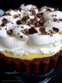 Homemade banana cream pie, nestled into a chocolate cookie crust, topped with freshly whipped cream and butter toffee. Get the recipe on ComfortablyDomestic.com