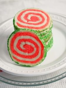 Peppermint shortbread pinwheel cookies are the perfect cookie recipe to make for your holiday cookie platter! Buttery vanilla and peppermint shortbread, presented in a fun pinwheel design. Edged in colored sugar, for an added touch of holiday sparkle. | ComfortablyDomestic.com