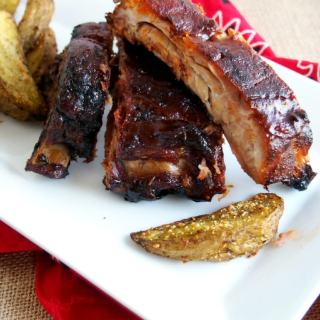 Perfect Barbecued Ribs are slow roasted and finished on the grill with a sticky-sweet sauce, for ribs that are fall-off-the-bone tender.