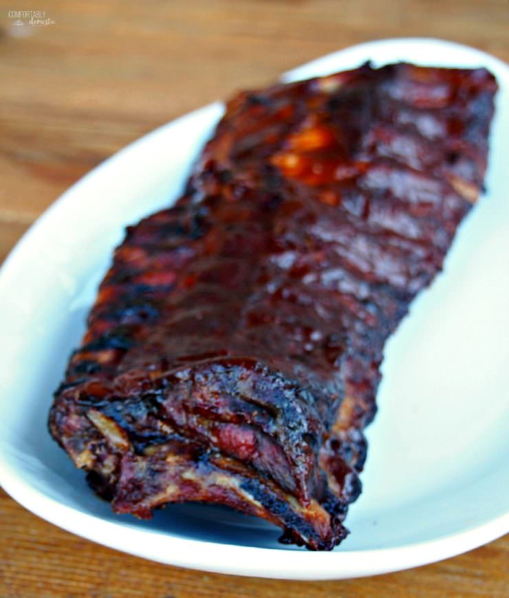 Perfect Barbecued Ribs are slow roasted and finished on the grill with a sticky-sweet sauce, for ribs that are fall-off-the-bone tender.