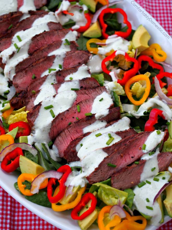 Grilled Steak Salad - Grilled steak sliced over colorful greens, sweet bell peppers, avocado, and thinly shaved red onion Drizzled with healthy, flavorful chive yogurt dressing. | ComfortablyDomestic.com