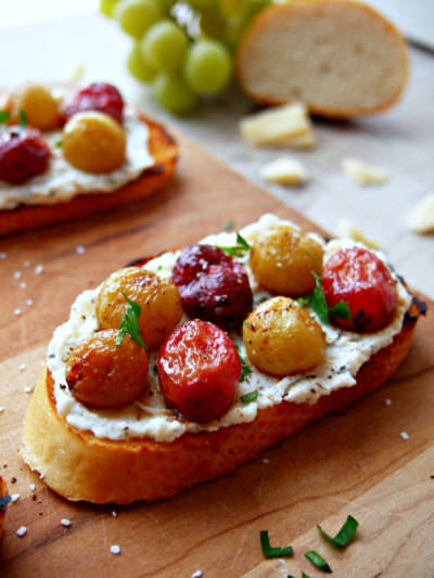 Roasted-Grapes-Crostini caramelizes sweet grapes with a light balsamic dressing before nestling them on a savory bed of ricotta and crisp, buttery toast. This is one appetizer to remember!